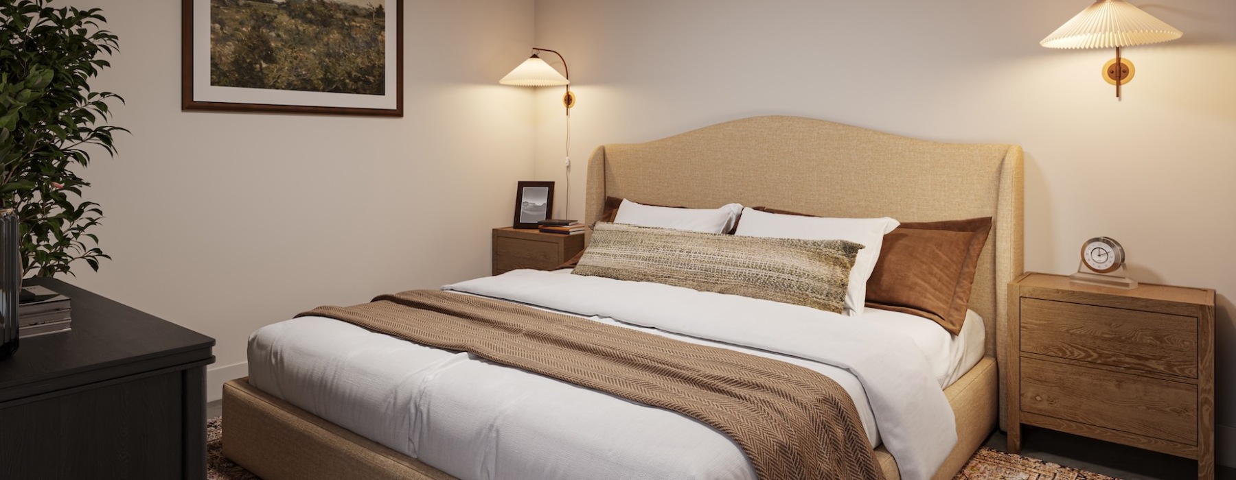 Bedroom with large bed, lamps, end tables, and a picture on the wall. 