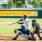 Baseball player hitting a ball with two people behind them