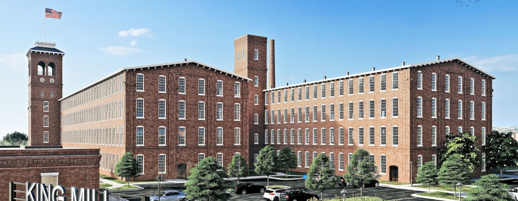 a large brick building with a flag on top